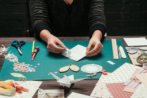 Cropped image of woman making scrapbooking postcard — Stock Photo