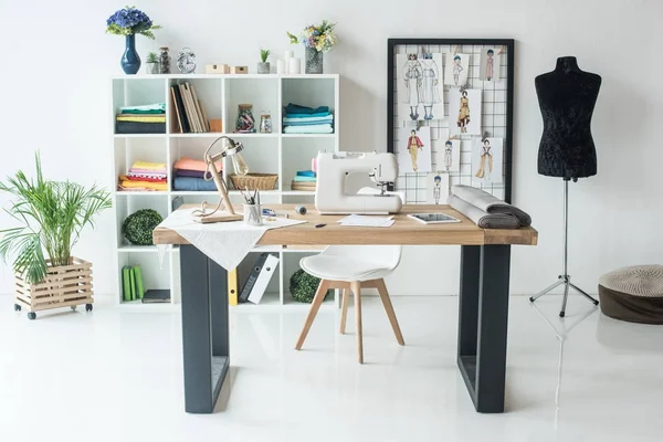 Seamstress workplace with sewing machine on table — Stock Photo