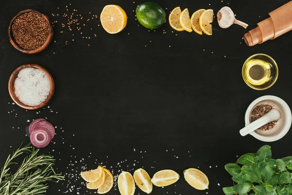 Top view of various spices and seasonings on black with copy space — Stock Photo