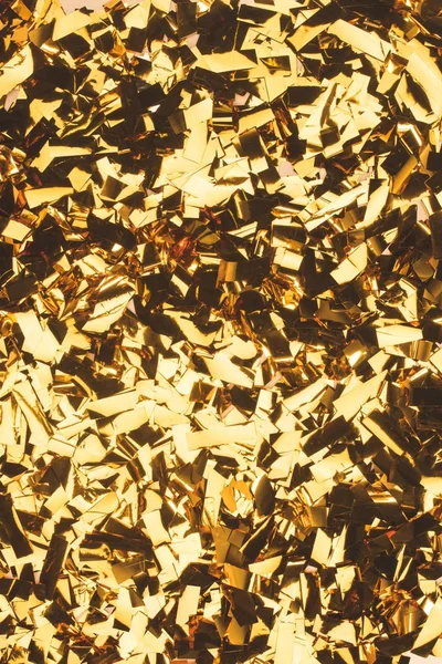 Close up view of sparking golden confetti — Stock Photo