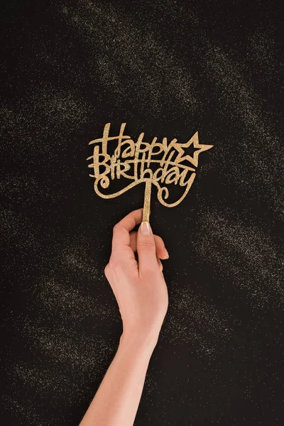 Cropped shot of female hand holding happy birthday sign — Stock Photo