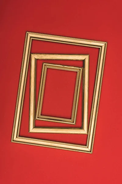 Top view of arranged of golden photo frames isolated on red — Stock Photo