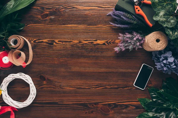 Top view of smartphone on florist working table — Stock Photo