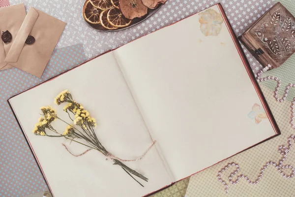Top view of opened book with flowers and copy space — Stock Photo
