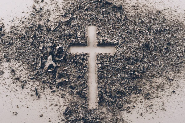 Top view of cross shape from ash on white table — Stock Photo