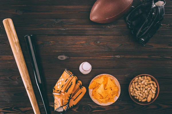 Top view of various snacks and sports equipment on wooden table — Stock Photo