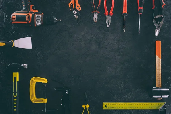 Top view of set of mechanical equipment on dark tabletop — Stock Photo