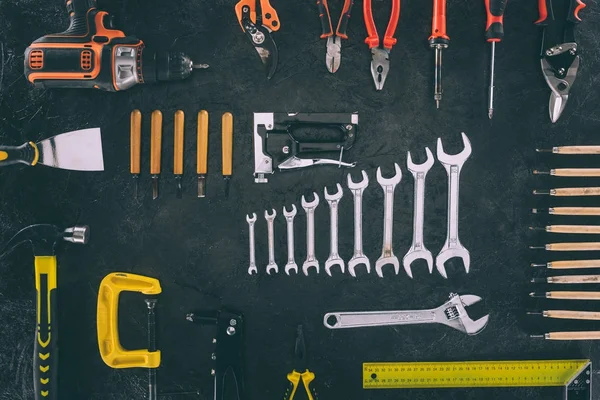 Top view of set of mechanical equipment on dark tabletop — Stock Photo