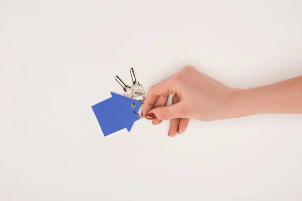 Cropped image of female hand holding key from house isolated on white — Stock Photo