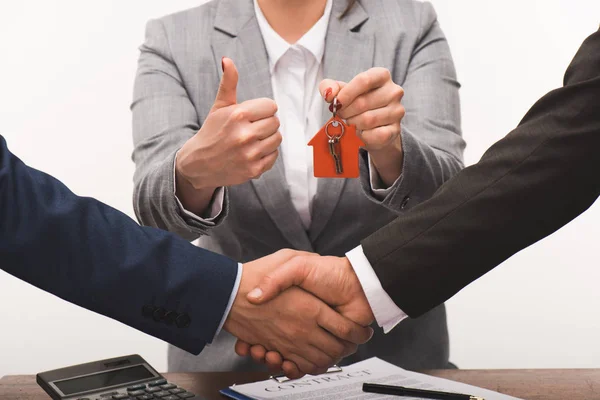 Cropped image of costumer and estate agent shaking hands, realty buying concept isolated on white — Stock Photo