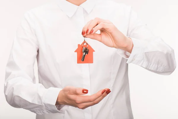 Cropped image of female holding key from house isolated on white — Stock Photo