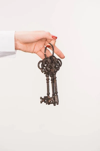 Cropped image of female hand holding vintage keys isolated on white — Stock Photo