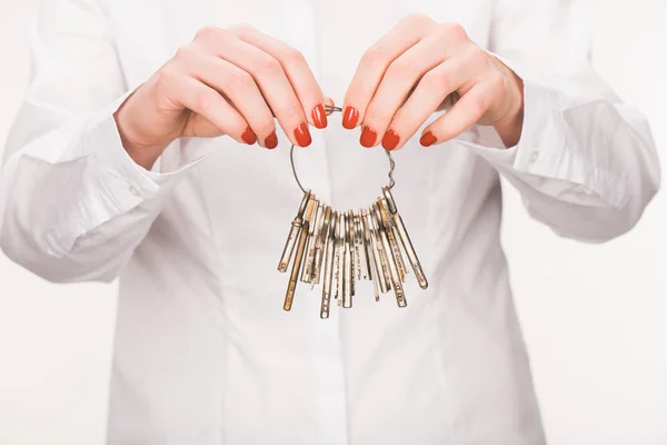 Cropped image of female holding keys isolated on white — Stock Photo