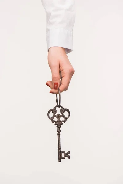 Cropped image of female hand holding vintage key isolated on white — Stock Photo