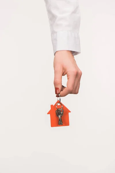 Cropped image of female hand holding key from house isolated on white — Stock Photo