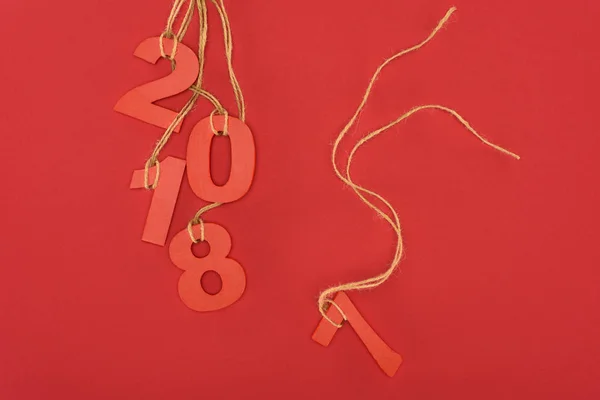 Close up view of 2018 year sign hanging on strings isolated on red — Stock Photo