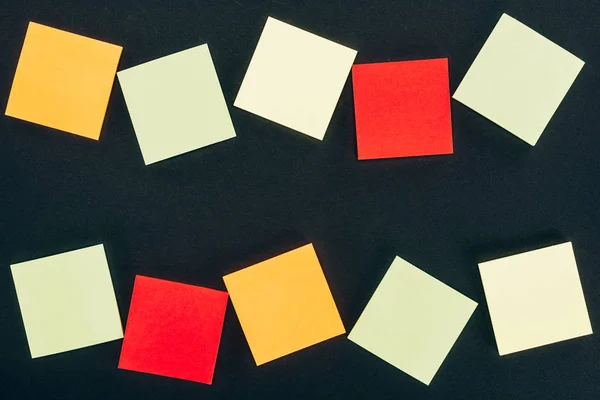Top view of various colorful blank notes on black — Stock Photo