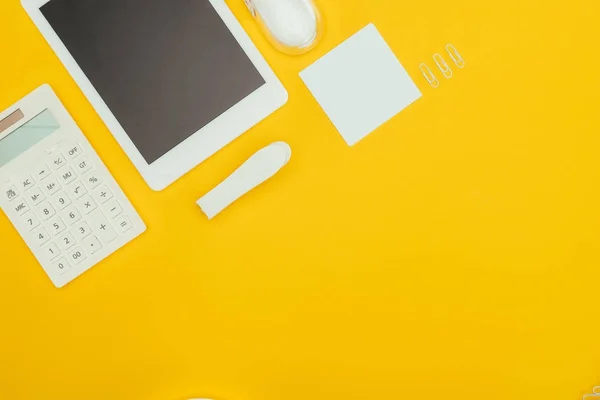 Vista superior do tablet digital com tela em branco, calculadora e material de escritório isolado em amarelo — Fotografia de Stock