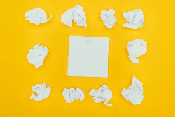 Top view of crumpled papers and blank notes isolated on yellow — Stock Photo