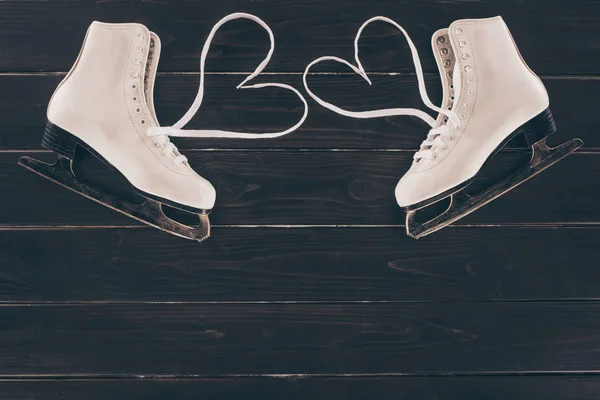 Top view of white skates with hearts shaped shoelaces — Stock Photo