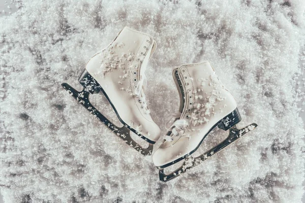 Top view of pair of white skates under snow — Stock Photo