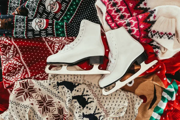 Top view of pair of white skates on winter clothes — Stock Photo