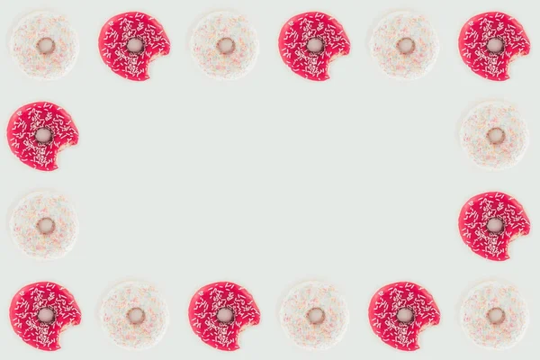 Top view of frame made of pink and white glazed doughnuts isolated on white — Stock Photo