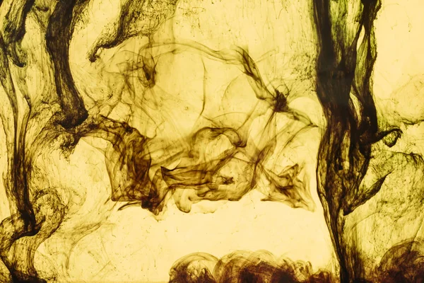 Full frame of yellow paint splashes and swirls — Stock Photo