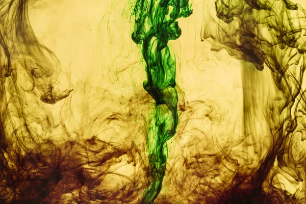 Full frame of yellow and green paint splashes and swirls — Stock Photo