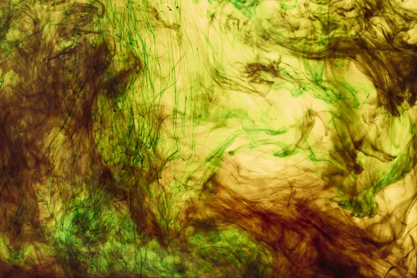 Full frame of yellow and green paint splashes and swirls — Stock Photo