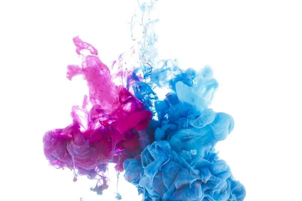 Mixing of blue and pink paint splashes isolated on white — Stock Photo