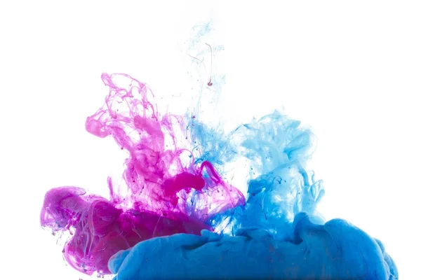 Mixing of blue and pink paint splashes isolated on white — Stock Photo