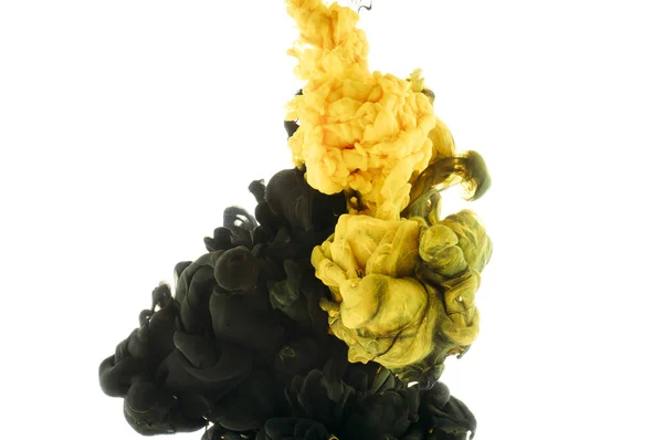 Mixing of black and yellow paint splashes, isolated on white — Stock Photo