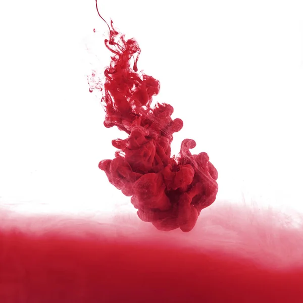 Close up view of red paint splash in water, isolated on white — Stock Photo