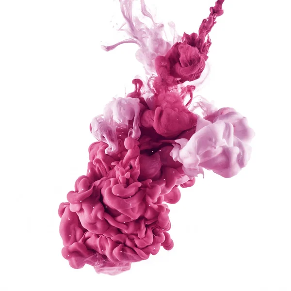 Spruzzi di vernice rosa e rosa chiaro in acqua, isolati su bianco — Foto stock