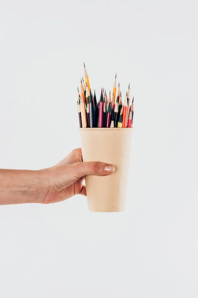 Nahaufnahme der weiblichen Hand hält Tasse mit bunten Bleistiften isoliert auf weißem Hintergrund — Stockfoto
