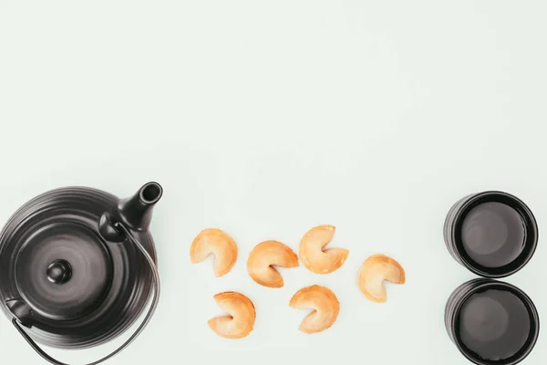 Top view of chinese teapot with fortune cookies isolated on white — Stock Photo