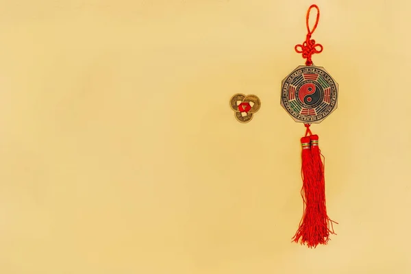 Top view of chinese yin and yang talisman with coins on yellow — Stock Photo