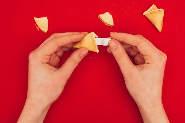 Cropped shot of woman opening chinese fortune cookie, Chinese New Year concept — Stock Photo