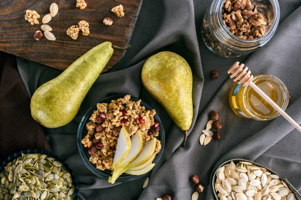 Top view of pears, honey and homemade granola on tabletop — Stock Photo