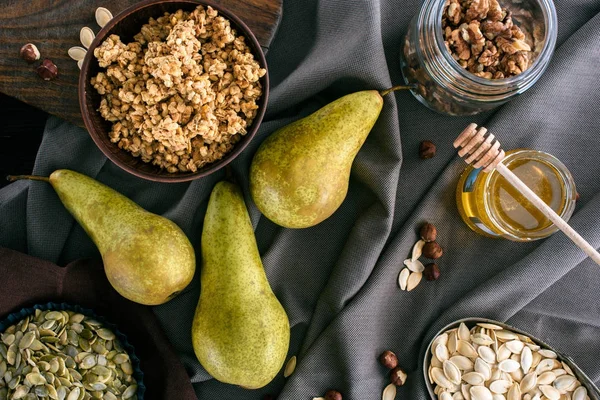 Top view of pears, honey and homemade granola on table — Stock Photo