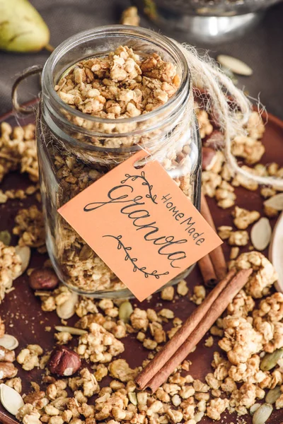 Overhead view of homemade granola in glass jar with tag — Stock Photo