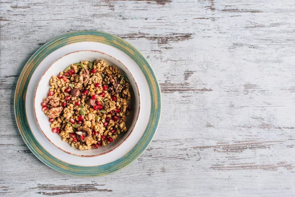 Top view of plate with homemade granola on grungy table — Stock Photo