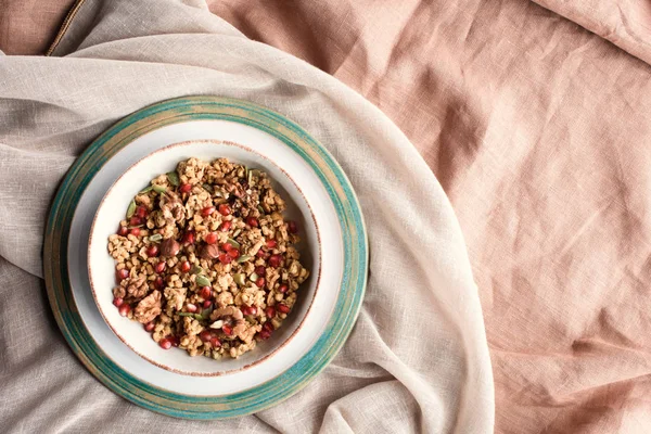 Top view of plate with homemade granola on beige tablecloth — Stock Photo