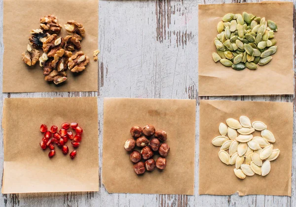 Top view of nuts, pumpkin seeds and pomegranate seeds on table — Stock Photo