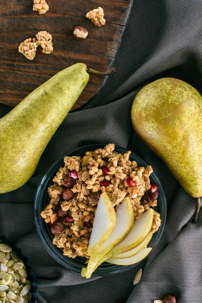 Top view of homemade granola and pears on table — Stock Photo
