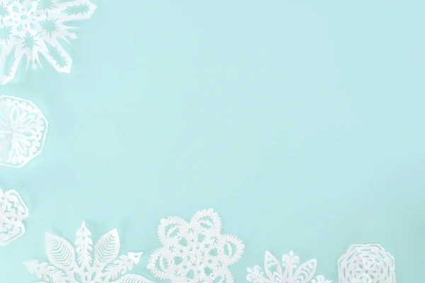 Decorative christmas snowflakes, isolated on light blue with copy space — Stock Photo