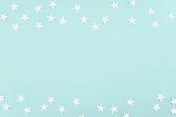 Background with white paper stars, isolated on light blue — Stock Photo