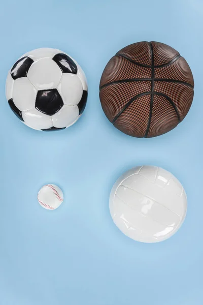 Balls for baseball, soccer, volleyball and basketball isolated on blue — Stock Photo