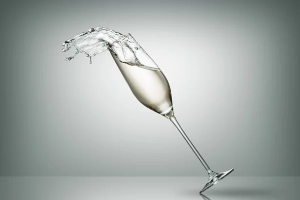 Splash of champagne from falling glass on white — стоковое фото